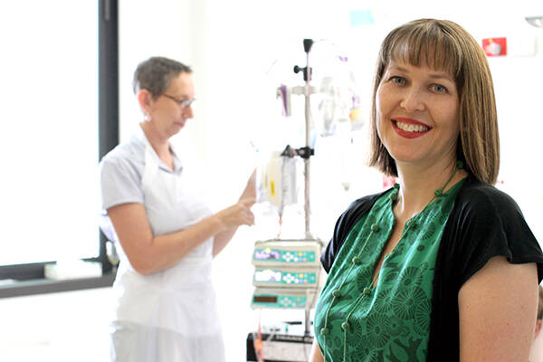 Professor Rickard in foreground with a nurse adjusting an infusion set in the background