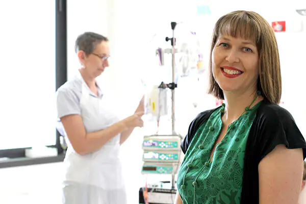 Professor Rickard in foreground with a nurse adjusting an infusion set in the background