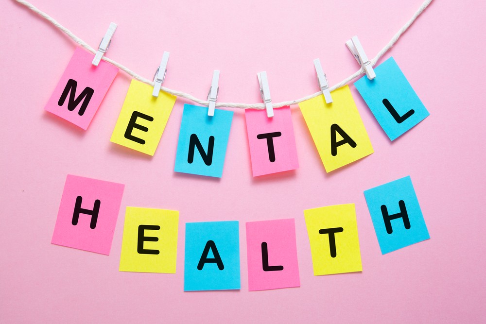 Major expansion of community mental health support Mental health word writen on colorful sticky notes over pink bright background