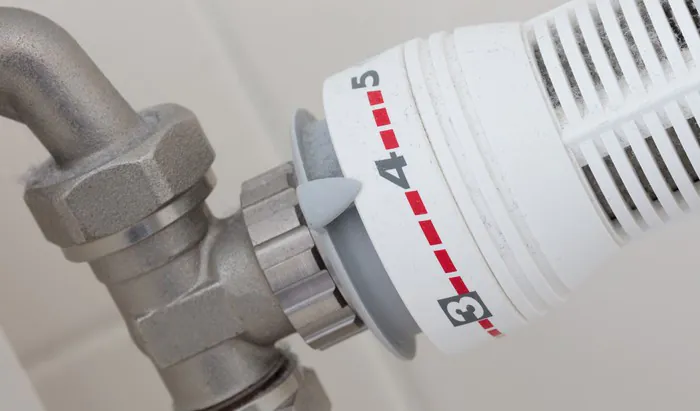 Game-changing drug for hot flushes Temperature knob of heating radiator, used and dusty